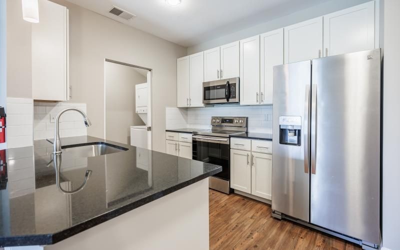 a kitchen with white cabinets
