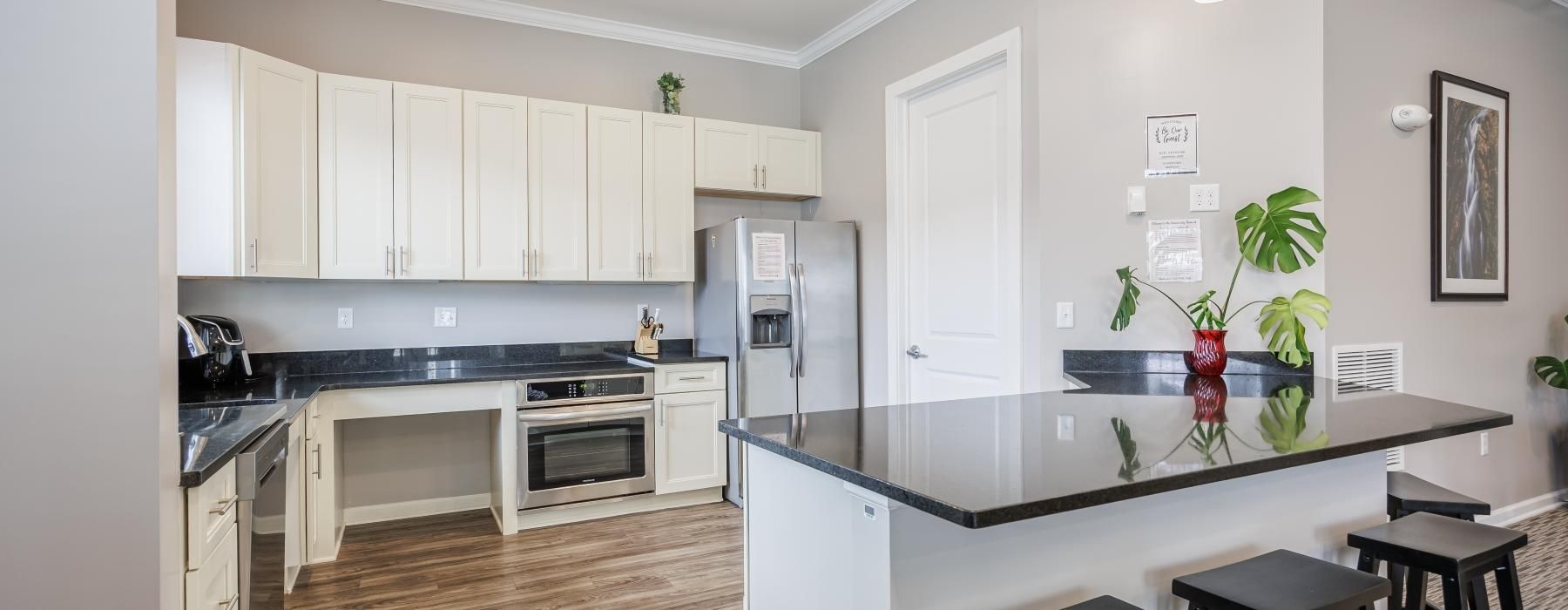 a kitchen with a bar stool and a table