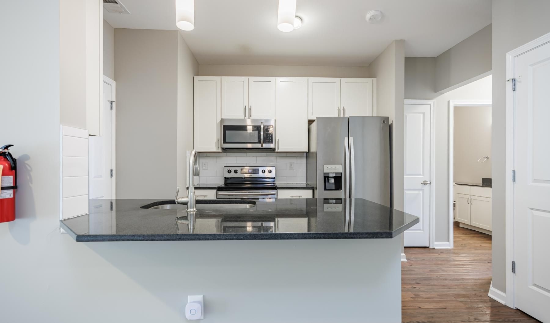 a kitchen with white cabinets